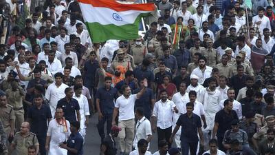 Congress party leader Rahul Gandhi waves as he walks with other leaders during his Bharat Jodo Yatra, in Hyderabad. (AP)