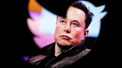 Elon Musk's photo is seen through a Twitter logo in this illustration. (REUTERS)