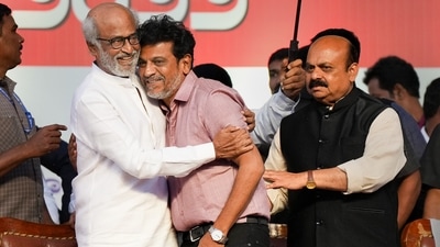 Actors Rajinikanth hugs actor Shiva Rajkumar as Karnataka Chief Minister Basavaraj Bommai looks on, during a ceremony for the Karnataka Ratna Award presentation. (PTI) Actors Rajinikanth hugs actor Shiva Rajkumar as Karnataka Chief Minister Basavaraj Bommai looks on, during a ceremony for the Karnataka Ratna Award presentation. (PTI)