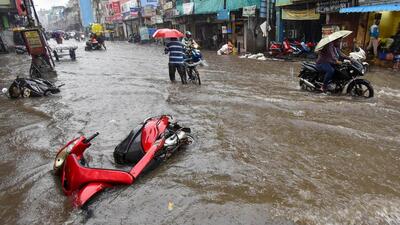 Partially submerged two-wheelers on a waterlogged road during heavy rainfall in Chennai on Tuesday. (PTI Photo) Partially submerged two-wheelers on a waterlogged road during heavy rainfall in Chennai on Tuesday. (PTI Photo)