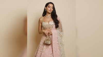 Nora Fatehi lehenga comes with a golden blouse featuring a plunging neckline and a matching dupatta. (Instagram/@norafatehi05) Nora Fatehi lehenga comes with a golden blouse featuring a plunging neckline and a matching dupatta. (Instagram/@norafatehi05)