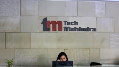 An employee sits at the front desk inside Tech Mahindra’s office in Noida in this file photo. (Reuters Photo)