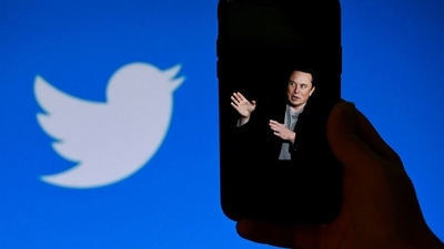 A phone screen displays a photo of Elon Musk with the Twitter logo. (AFP) A phone screen displays a photo of Elon Musk with the Twitter logo. (AFP)