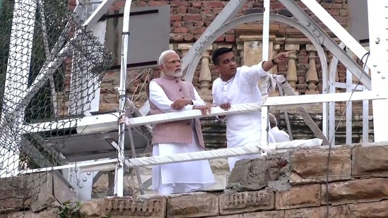Prime Minister Narendra Modi with Gujarat minister of state for home Harsh Sanghavi reviews the search and rescue operation.(ANI)