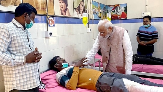 Prime Minister Narendra Modi meets an injured person of the Morbi cable bridge collapse mishap, at the Civil Hospital.(ANI)