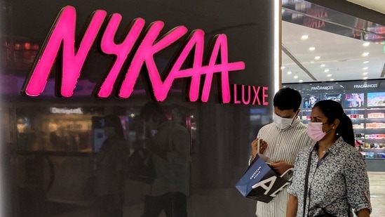 People walk past a store of Nykaa at a mall in New Delhi.(Reuters)