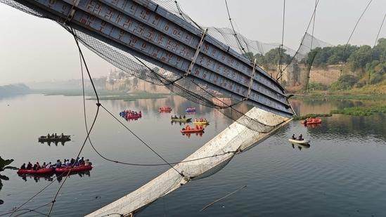 Rescue personnel conduct search operations after a bridge across the river Machchhu collapsed at Morbi in Gujarat. (AFP)