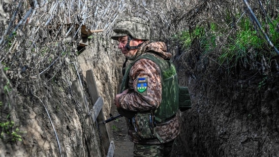 Russia-Ukraine War: A Ukrainian soldier walks along a trench at the Kherson border region. (AFP)