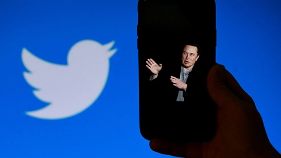 A phone screen displays a photo of Elon Musk with the Twitter logo.(AFP)