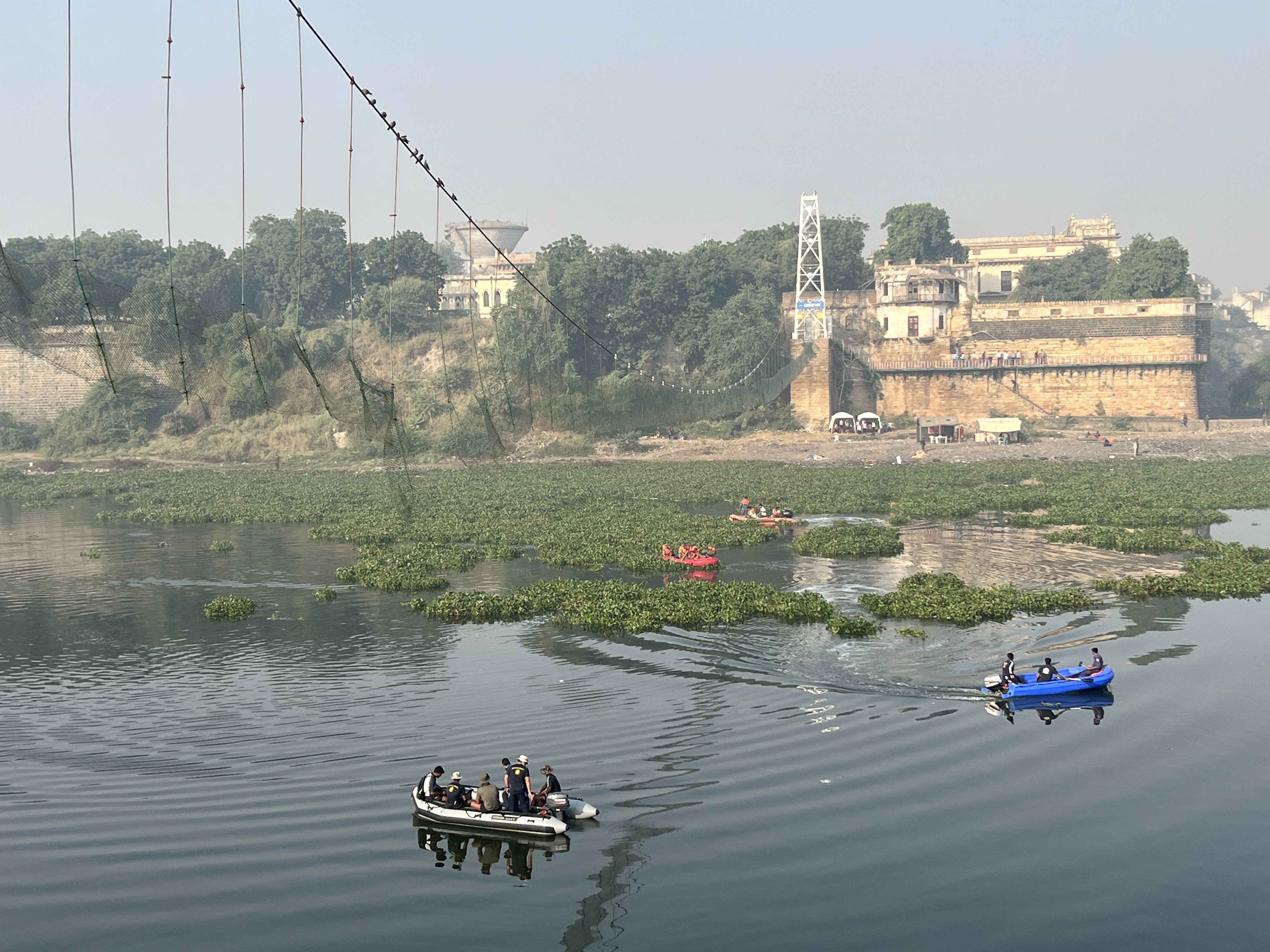 Rescue operation underway after the collapse of a suspension bridge over the Machchhu river, in Morbi district, Tuesday, November 1, 2022. (PTI Photo)