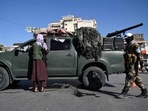 Afghanistan: Taliban fighters stand guard as they block a road near Kabul. Afghanistan: Taliban fighters stand guard as they block a road near Kabul.