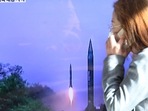 North Korea Missile Launch: A woman walks past a TV screen broadcasting a news report on North Korea firing a ballistic missile.