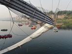 Rescue personnel conduct search operations after a bridge across the river Machchhu collapsed at Morbi in Gujarat. (AFP) Rescue personnel conduct search operations after a bridge across the river Machchhu collapsed at Morbi in Gujarat. (AFP)