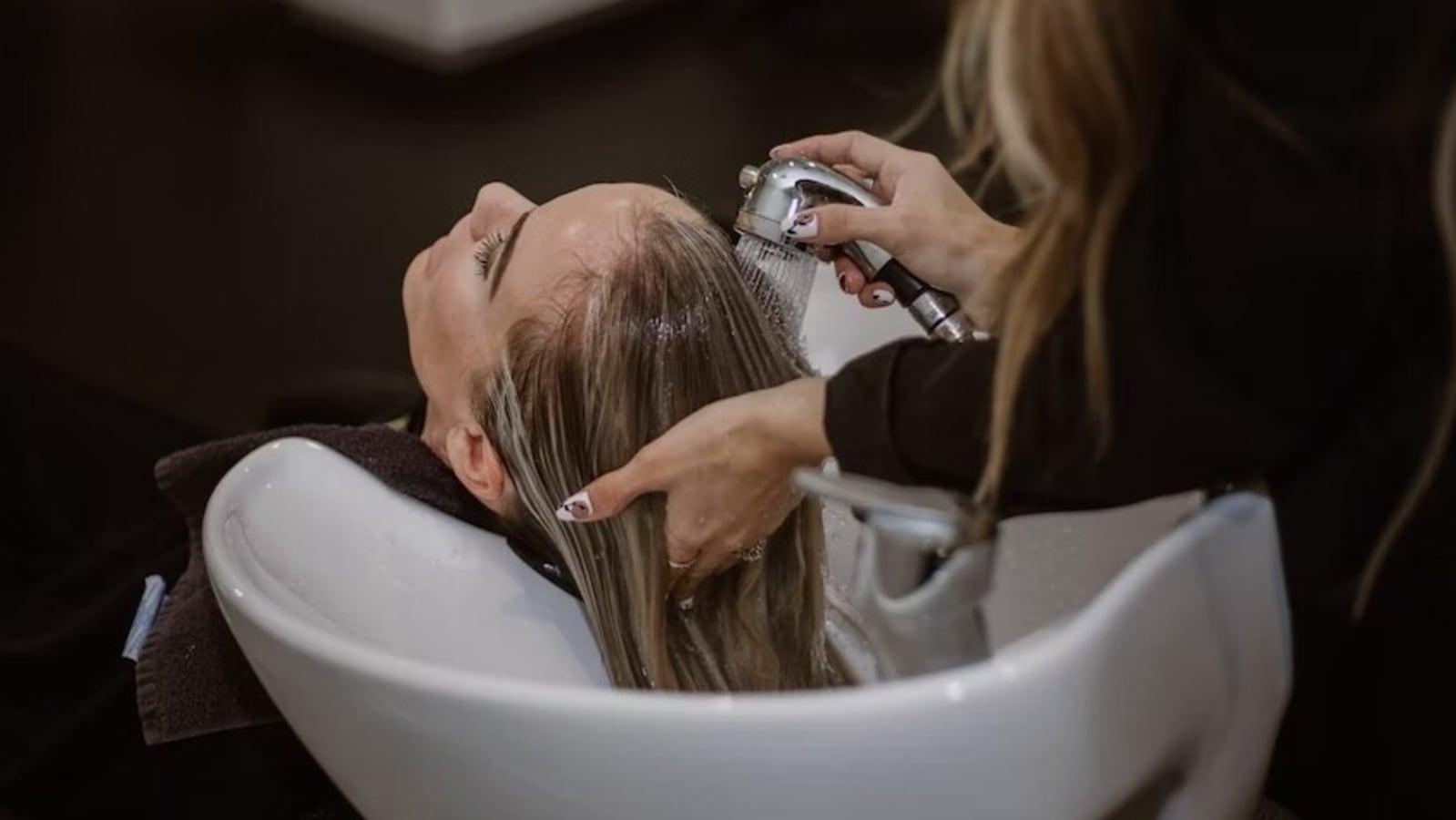 Premium Photo  Beautiful young woman washes hair in a beauty salon