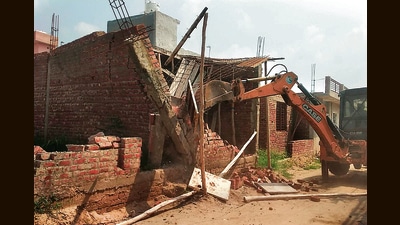 An illegal structure being demolished at Sahora village in Kharar on Wednesday.