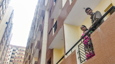 People from the economically weaker section pose for photos from the balcony of a newly constructed flat as part of the In-Situ Slum Rehabilitation project, at Kalkaji in New Delhi, Wednesday. Prime Minister Narendra Modi will hand over 3,024 newly constructed flats for the EWS on Wednesday. (PTI) People from the economically weaker section pose for photos from the balcony of a newly constructed flat as part of the In-Situ Slum Rehabilitation project, at Kalkaji in New Delhi, Wednesday. Prime Minister Narendra Modi will hand over 3,024 newly constructed flats for the EWS on Wednesday. (PTI)