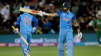 Virat Kohli raises his bat after scoring a half-century during the T20 World Cup match between India and Bangladesh, at Adelaide Oval (PTI) Virat Kohli raises his bat after scoring a half-century during the T20 World Cup match between India and Bangladesh, at Adelaide Oval (PTI)