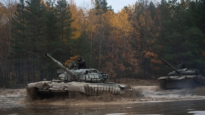 Russia-Ukraine War: A car passes as city lighting turned off at twilight in Kyiv. (AP)