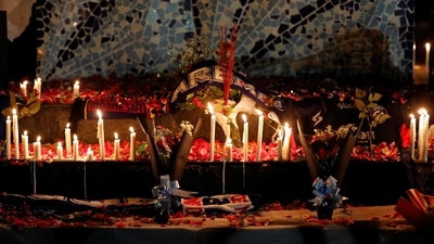 Indonesia Soccer Stampede: Candles, petals, and incenses placed by Arema FC supporters are seen during a vigil to pay condolence to the victims. (Reuters)