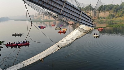 Rescue personnel conduct search operations after a bridge across the river Machchhu collapsed at Morbi in Gujarat. (AFP) Rescue personnel conduct search operations after a bridge across the river Machchhu collapsed at Morbi in Gujarat. (AFP)