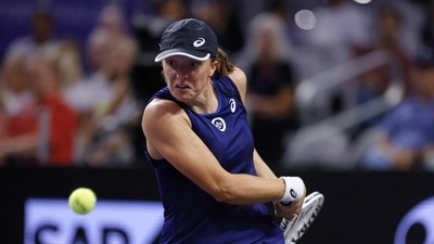 Iga Swiatek of Poland returns a shot to Daria Kasatkina of Russia during round robin play on day two of the WTA Finals tennis tournament (AP) Iga Swiatek of Poland returns a shot to Daria Kasatkina of Russia during round robin play on day two of the WTA Finals tennis tournament (AP)
