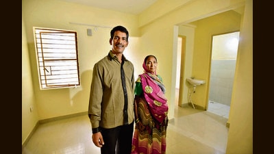 Surajmukhi and her son at their new flat, part of the in-situ slum rehabilitation project at Kalkaji Extension. (Sanjeev Verma/HT)