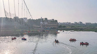 Rescue operation underway after the collapse of a suspension bridge over the Machchhu river, in Morbi district, Wednesday, Nov. 2, 2022. The collapse of the bridge on Sunday evening claimed atleast 135 lives. (PTI)
