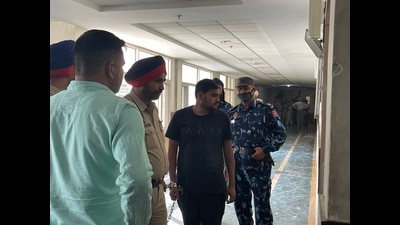 Arrested gym owner Kuldeep Kohli (in black) being produced before a Mohali court on Wednesday. (HT Photo)