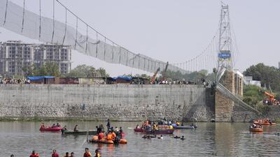 Rescuers in boats search the Machchu river next to a cable bridge that collapsed in Morbi town of Gujarat. (AP)