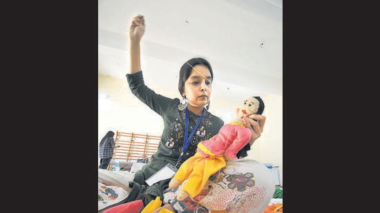 A participant at the doll-making competition during the youth fest at DAV College, Sector 10, on Wednesday. (Ravi Kumar/HT)
