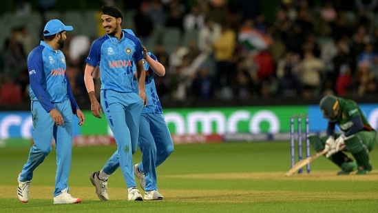 Arshdeep Singh celebrates with Rohit Sharma during the ICC T20 World Cup 2022 match between India and Bangladesh(AFP)