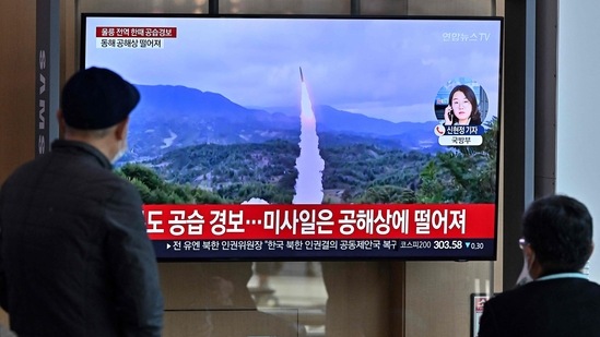 North Korea Missile Launch: People watch a television screen showing a news broadcast with file footage of a North Korean missile test. (AFP)