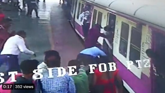 The officer in blue shirt seen rescuing the child after he fell from his mother's arms.(Twitter/@RPFCRBB)