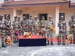 The image, taken from the video, shows CISF personnel posing for a picture along with their canine heroes. (Twitte/@KochiAirport) The image, taken from the video, shows CISF personnel posing for a picture along with their canine heroes. (Twitte/@KochiAirport)