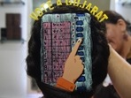 A beautician gives finishing touches as she paints 'Electronic Voting Machine' (EVM) on the hair of a woman in Ahmedabad.(AFP / File) A beautician gives finishing touches as she paints 'Electronic Voting Machine' (EVM) on the hair of a woman in Ahmedabad.(AFP / File)
