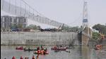 Rescuers in boats search the Machchu river next to the bridge that collapsed in Morbi. (AP) Rescuers in boats search the Machchu river next to the bridge that collapsed in Morbi. (AP)