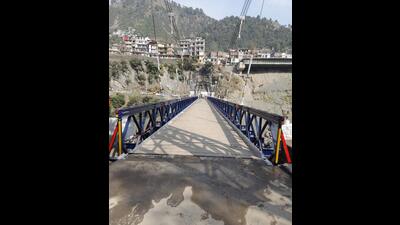 Completed a month before its deadline by the Border Roads Organisation (BRO), the 240ft bailey suspension reinforced bridge over Chenab in Ramban was informally thrown open for traffic on Wednesday. (HT Photo)