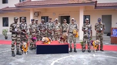 The image, taken from the video, shows CISF personnel posing for a picture along with their canine heroes. (Twitte/@KochiAirport) The image, taken from the video, shows CISF personnel posing for a picture along with their canine heroes. (Twitte/@KochiAirport)