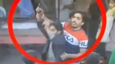 The attacker( in black) who allegedly opened fire at Imran Khan's rally. (ARY news) The attacker( in black) who allegedly opened fire at Imran Khan's rally. (ARY news)