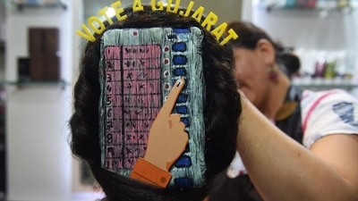 A beautician gives finishing touches as she paints 'Electronic Voting Machine' (EVM) on the hair of a woman in Ahmedabad. (AFP / File) A beautician gives finishing touches as she paints 'Electronic Voting Machine' (EVM) on the hair of a woman in Ahmedabad. (AFP / File)
