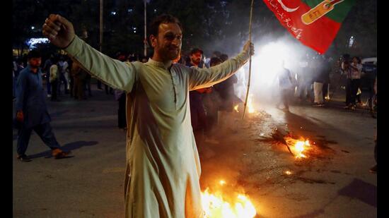 A supporter of Pakistan former Prime Minister Imran Khan, gestures following the shooting incident on his long march in Wazirabad, during a protest in Karachi, (Reuters)