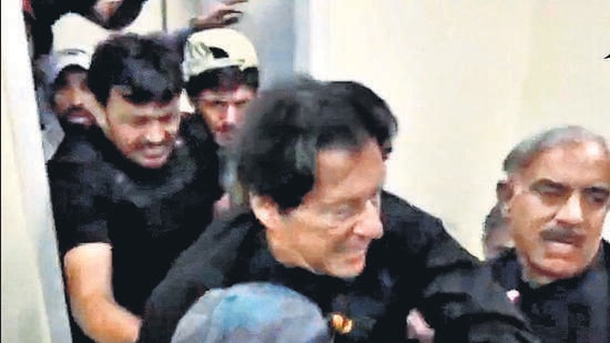 Former Pakistani Prime Minister Imran Khan is helped after he was shot in the shin in Wazirabad, Pakistan November 3, 2022 in this still image obtained from video. (Urdu Media via REUTERS) Former Pakistani Prime Minister Imran Khan is helped after he was shot in the shin in Wazirabad, Pakistan November 3, 2022 in this still image obtained from video. (Urdu Media via REUTERS)