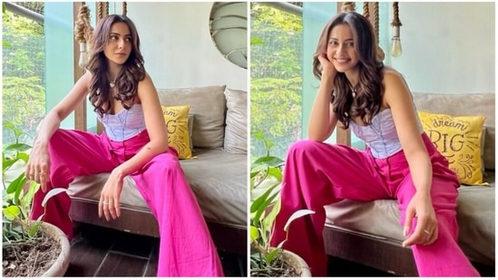 Rakul Preet's fashion sense only keeps getting better and better every day. The actor has finally returned home from her Maldives vacation and is happy to be back. She recently shared pictures of herself from her living room dressed in a corset strapless top took and pink trousers.(Instagram/@rakulpreet)