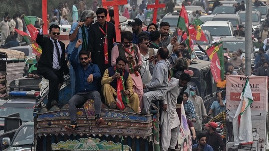 Khan with later seen with a bandage on his foot. He was moved to another vehicle from his container truck, from where announcements were being made that he was safe. Image dated November 1.(AFP)