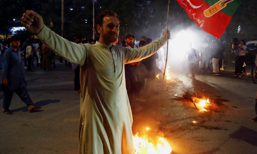 A supporter of Pakistan former Prime Minister Imran Khan, gestures following the shooting incident on his long march in Wazirabad, during a protest in Karachi, (Reuters) A supporter of Pakistan former Prime Minister Imran Khan, gestures following the shooting incident on his long march in Wazirabad, during a protest in Karachi, (Reuters)