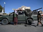 Afghanistan: Taliban fighters stand guard as they block a road near Kabul. Afghanistan: Taliban fighters stand guard as they block a road near Kabul.