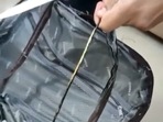 A video shared by the customs department shows the outer lining of the bag being cut open to reveal what seems to be an ordinary metal ring.(Chennai customs/ Twitter) A video shared by the customs department shows the outer lining of the bag being cut open to reveal what seems to be an ordinary metal ring.(Chennai customs/ Twitter)