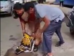 The couple was seen filling up a pothole after the husband went through a 'near-death' accident but escaped unhurt.