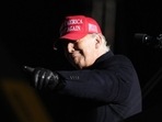 Former President Donald Trump reacts to a supporter during a rally, Thursday.
