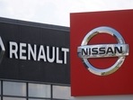 The logos of car manufacturers Nissan and Renault are pictured at a dealership.